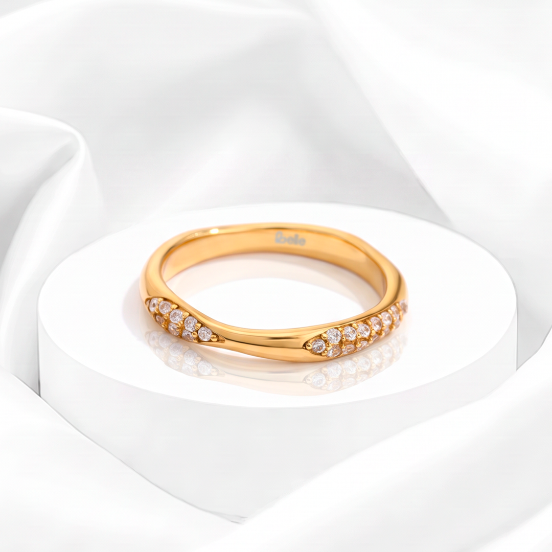 Anillo curvo para mujer marca Belle en acero bañado en oro de 18k con pavé de circonias blancas en los extremos.