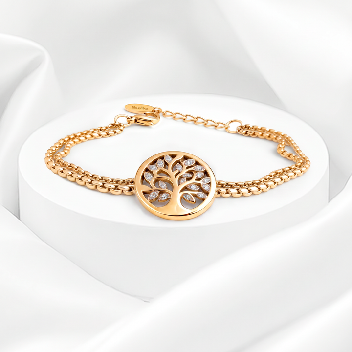 Pulsera semirrígida de mujer en acero quirúrgico 316 con baño de oro de 18k, de doble cadena trenzada y dije circular calado del Árbol de la Vida con cristales blancos.