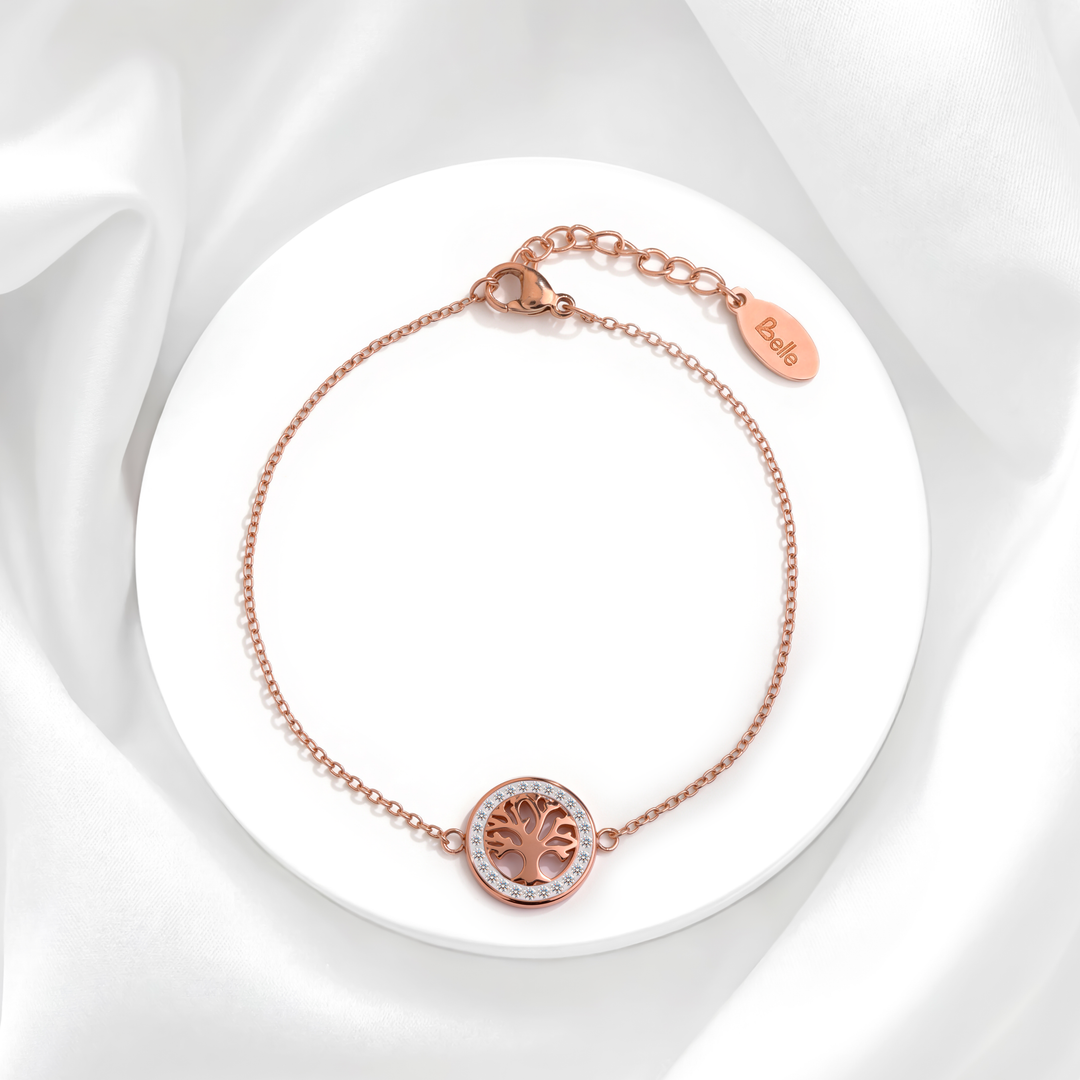 Pulsera de tres hilos para mujer en acero quirúrgico 316 baño oro rosa 18k con dije circular del árbol de la vida y cristales blancos sobre base redonda.